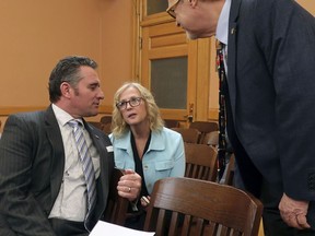 In this Wednesday, Feb. 13, 2019 photo, Kansas state Sens. Ty Masterson, left to right, R-Andover; Mary Pilcher-Cook, R-Shawnee; and Eric Rucker, R-Topeka; confer following a meeting of GOP senators at the Statehouse in Topeka, Kan. All three are abortion opponents and sponsors of a resolution condemning New York's new abortion law.