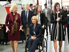 U.S. Secretary of Education Betsy DeVos, seated, tours a technical college in Florence, S.C., Thursday, Feb. 21, 2019, with state Education Superintendent Molly Spearman, left, and Lt. Gov. Pamela Evette, right. DeVos made a trip to the state to visit an area once known as the "Corridor of Shame" where officials say dramatic improvements have been made in schools since state officials took over their control last year.