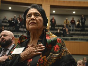 Dolores Huerta, 88, the Mexican-American social activist who formed a farmworkers union with Cesar Chavez, stands for the Pledge of Allegiance in Spanish while visiting the New Mexico Statehouse on Wednesday, Feb. 27, 2019. The New Mexico-born Huerta was honored by the House for "Dolores Huerta Day" as lawmakers work to save her birthplace in Dawson, New Mexico.