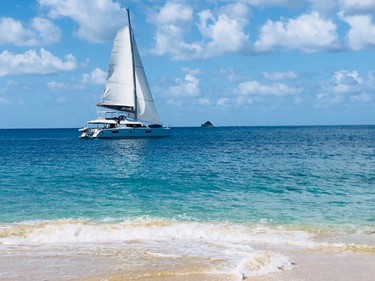 The catamaran leisurely sails past Mayreau.