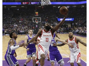 Houston Rockets guard James Harden, center goes to the basket against Sacramento Kings' Buddy Hield, left, and others during the first quarter of an NBA basketball game Wednesday, Feb. 6, 2019, in Sacramento, Calif.