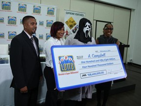 Cheque in hand! A. Campbell won the lottery in Jamaica but wanted his identity kept secret.