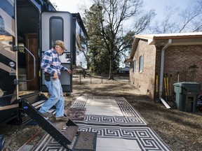 Kevin Tovornik exits his travel camper located in the back yard of his home damaged by flooding from Hurricane Florence near the Crabtree Swamp Friday, Feb. 1, 2019, in Conway, S.C. Tovornik lost his air conditioner and duct work in the 2016 flood. In 2018, he saved his furniture, but still ended up losing the house.