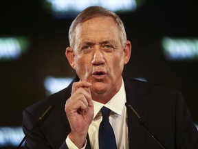 FILE - In this Tuesday, Jan. 29, 2019, file photo, former Israeli Chief of Staff Benny Gantz speaks at the official launch of his election campaign in Tel Aviv, Israel. Gantz, the leading challenger to Israel Prime Minister Benjamin Netanyahu, said in a published interview Wednesday, Feb. 6, 2019, that Israel should "find a way" to end its control over the Palestinians.