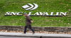 A man walks past the headquarters of SNC-Lavalin in Montreal.