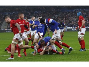France's Louis Picamoles, lower center, scores the opening try during the Six Nations rugby union international between France and Wales at the Stade de France in Saint Denis near Paris, Friday, Feb. 1, 2019.