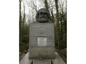 FILE - March 15, 2009 file photo of the grave of Marxist philosopher Karl Marx in Highgate Cemetery, in London. Custodians of a London cemetery say the tombstone of Communist thinker Karl Marx has been damaged in a hammer attack. The German philosopher was buried in Highgate Cemetery after his death in 1883, and his grave was later topped with a large granite bust bearing the words "Workers of all lands unite."