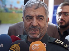 FILE - In this Oct. 31, 2017, file photo, the head of Iran's paramilitary Revolutionary Guard Gen. Mohammad Ali Jafari speaks to journalists after his speech at a conference called "A World Without Terror," in Tehran, Iran. Jafari has threatened to retaliate against neighboring Saudi Arabia and United Arab Emirates over a suicide car bombing on Wednesday, Feb. 13, 2019 that killed 27 members of the elite organization.