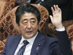 Japanese Prime Minister Shinzo Abe raises his hand during a parliamentary session at the Lower House in Tokyo, Monday, Feb. 18, 2019. Abe and his chief spokesman have declined to say if Abe nominated President Donald Trump for a Nobel Peace prize. Speaking in parliament on Monday, Abe said the Nobel committee has never in a half-century disclosed the identity of the person or groups behind such nominations. He said, "I thus decline comment."(Kyodo News via AP)