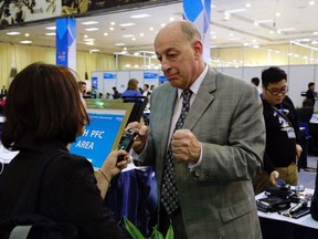 In this Wednesday, Feb. 27, 2019, photo, Robert Constantini, the White House correspondent for Westwood One News, a U.S radio news network, talks to a journalist at the media center in Hanoi, Vietnam. In welcoming more than 2,600 foreign journalists, Vietnam has a unique opportunity to polish its image and, hopefully, boost tourism and investment. Vietnamese are keen to show themselves as members in good standing of the global community, to the extent of helping broker a major diplomatic entente as North Korean leader Kim Jong Un and U.S. President Donald Trump meet for a second time to discuss North Korea's nuclear program.