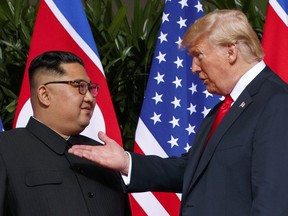 FILE - In this June 12, 2018, file photo, U.S. President Donald Trump, right, meets with North Korean leader Kim Jong Un on Sentosa Island in Singapore. With their second summit fast approaching, speculation is growing that Trump may try to persuade Kim to commit to denuclearization by giving him something he wants more than almost anything else, an announcement of peace and an end to the Korean War.