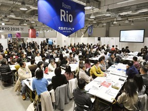 In this Feb. 9, 2019, photo, invitees listen during an orientation for volunteers for the Tokyo 2020 Olympics and Paralympics in Tokyo. Unpaid Olympic volunteers do almost everything: guide athletes around, greet dignitaries, and translate for lost fans. IOC officials acknowledge the games couldn't be held without them; invariably smiling, helpful and praised by presidents, prime ministers, and monarchs. That's the case at next year's Tokyo Olympics and Paralympics where about 80,000 will be needed. Just over 200,000 have applied with orientation and interviews for Japan residents starting this month.
