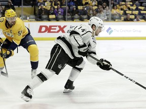 Los Angeles Kings left wing Brendan Leipsic (14) moves the puck away from Nashville Predators defenseman Roman Josi (59), of Switzerland, during the first period of an NHL hockey game Thursday, Feb. 21, 2019, in Nashville, Tenn.