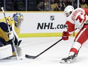 Detroit Red Wings center Andreas Athanasiou (72) shoots against Nashville Predators goaltender Pekka Rinne (35), of Finland, during the first period of an NHL hockey game Tuesday, Feb. 12, 2019, in Nashville, Tenn.