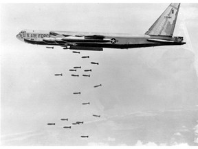 FILE - In this March 1966, file photo, a U.S. Air Force B-52 delivers a bomb load of more than 38,000 pounds against Viet Cong strongholds in South Vietnam during the Vietnam War. The Vietnamese capital Hanoi once trembled as waves of American bombers unleashed their payloads, but when Kim Jong Un arrives here for his summit with President Donald Trump he won't find rancor toward a former enemy. Instead, the North Korean leader will get a glimpse at the potential rewards of reconciliation. (AP Photo, File)