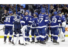The Tampa Bay Lightning celebrate their 4-3 shootout win over the Los Angeles Kings during an NHL hockey game Monday, Feb. 25, 2019, in Tampa, Fla.