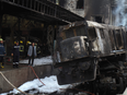 Firefighters and onlookers gather at the scene of a fiery train crash at the Egyptian capital Cairo's main railway station on Feb. 27, 2019.