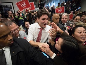Prime Minister Justin Trudeau, centre, campaigns with Richard T. Lee, second left, the Liberal candidate in the Burnaby South byelection, in Burnaby, B.C., on Sunday February 10, 2019.