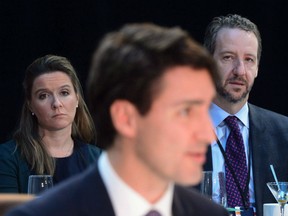Chief of staff Katie Telford, left, and principal secretary Gerald Butts look on as Prime Minister Justin Trudeau delivers his opening remarks during the Meeting of First Ministers in Ottawa on Friday, Dec. 9, 2016.