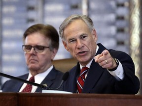 FILE - In a Tuesday, Feb. 5, 2019, file photo, Texas Gov. Greg Abbott, right, gives his State of the State Address as Lt. Gov. Dan Patrick, left, listens in the House Chamber in Austin, Texas. A federal judge says Texas counties may not remove any registered voters after state elections officials released an inaccurate list that questioned the U.S. citizenship of tens of thousands of people. U.S. District Judge Fred Biery ruled Wednesday, Feb. 27, 2019, "the state created this mess" and said there was no evidence of widespread voter fraud. He called Texas' efforts to find non-citizens on voting rolls "a solution looking for a problem."