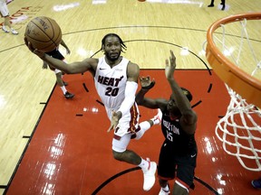 Miami Heat's Justise Winslow (20) shoots as Houston Rockets' Clint Capela (15) defends during the second half of an NBA basketball game Thursday, Feb. 28, 2019, in Houston. The Rockets won 121-118.