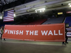 Workers prepare for a President Donald Trump campaign rally at El Paso County Coliseum, Monday, Feb. 11, 2019, in El Paso, Texas.