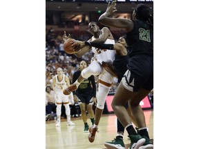 Texas forward Joyner Holmes, left, is blocked by Baylor forward NaLyssa Smith, center, as she drives to the basket during the first half of an NCAA college basketball game, Monday, Feb. 4, 2019, in Austin, Texas.