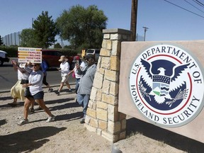 FILE - This June 2018 file photo shows protesters walking along Montana Avenue outside the El Paso Processing Center, in El Paso, Texas.  The U.S. government has suddenly stopped force-feeding a group of men on a hunger strike inside a Texas immigration detention center, U.S. Immigration and Customs Enforcement said Thursday, Feb. 14, 2019. The dramatic reversal comes as public pressure was mounting on ICE to halt the practice, which involves feeding detainees through nasal tubes against their will.
