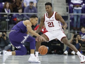 TCU guard Desmond Bane, left, tries to find a way past Oklahoma forward Kristian Doolittle (21) during the first half of an NCAA college basketball game in Fort Worth, Texas, Saturday, Feb. 16, 2019.