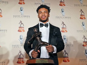 Heisman Trophy winner quarterback Kyler Murray posses with the Davey O'Brien football award he received in Fort Worth, Texas, Monday, Feb. 18, 2019. Murray accepted the Davey O'Brien award in his first public appearance since the Heisman Trophy winner announced his plan to pursue an NFL career rather than report to spring training as a first-round pick of the Oakland A's.