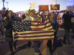 People march on a roadway behind the El Paso County Coliseum where President Donald Trump was scheduled to speak at a rally, Monday, Feb. 11, 2019, in El Paso, Texas. The counter-rally was organized by local immigrant rights organizations and former U.S. Rep. Beto O'Rourke spoke to the crowd.