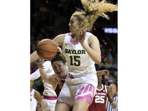 Oklahoma guard Jessi Murcer, left, passes the ball as Baylor forward Lauren Cox (15) defends during the first half of an NCAA college basketball game in Waco, Texas, Saturday, Feb. 16, 2019.