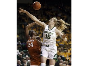 Texas guard Joyner Holmes (24) has her shot blocked by Baylor forward Lauren Cox (15) in the first half of an NCAA college basketball game in Waco, Texas, Monday, Feb. 25, 2019.