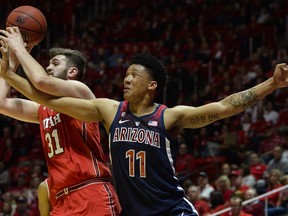 Utah center Brandon Morley (31) fights for the ball with Arizona forward Ira Lee (11) during the first half of an NCAA college basketball game Thursday, Feb. 14, 2019, in Salt Lake City.