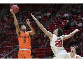 Oregon State guard Ethan Thompson (5) shoots the ball over Utah forward Timmy Allen (20) during the first half of an NCAA college basketball game, Saturday, Feb. 2, 2019, in Salt Lake City.