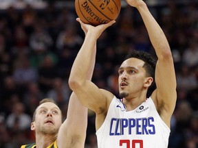 Los Angeles Clippers guard Landry Shamet (20) shoots as Utah Jazz forward Joe Ingles (2) defends in the first half during an NBA basketball game Wednesday, Feb. 27, 2019, in Salt Lake City.