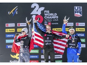 Silver medalist Hanno Douschan, left, of Austria, gold medalist Mick Dierdorff, center, of the United States, and bronze medalist Emanuel Perathoner, of Italy, celebrate on the podium after the men's snowboard cross final at the Freestyle Ski and Snowboard World Championships, Friday, Feb. 1, 2019, in Solitude, Utah.