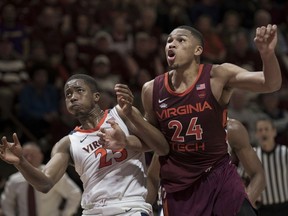 Virginia Tech forward Kerry Blackshear Jr.(24) and Virginia forward Mamadi Diakite (25) battle for position under the basket during a foul shot during the second half of an NCAA college basketball game in Blacksburg, Va., Monday, Feb. 18, 2019.