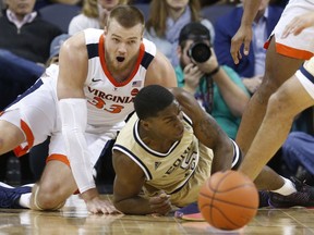 Georgia Tech forward Moses Wright (5) and Virginia center Jack Salt (33) scramble for a loose ball during the first half of an NCAA college basketball game in Charlottesville, Va., Wednesday, Feb. 27, 2019.