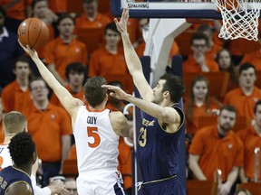 Virginia guard Kyle Guy (5) goes up for a shot as Notre Dame forward John Mooney (33) defends during the first half of an NCAA college basketball game in Charlottesville, Va., Saturday, Feb. 16, 2019.