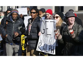 Demonstrators hold signs and chant outside the Governors office at the Capitol in Richmond, Va., Saturday, Feb. 2, 2019. The demonstrators are calling for the resignation of Virginia Governor Ralph Northam after a 30 year old photo of him on his medical school yearbook photo was widely distributed Friday.