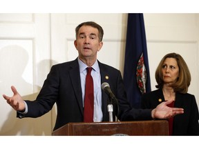 Virginia Gov. Ralph Northam, left, accompanied by his wife, Pam, speaks during a news conference in the Governor's Mansion in Richmond, Va., on Saturday, Feb. 2, 2019. Resisting widespread calls for his resignation, Northam on Saturday vowed to remain in office after disavowing a racist photograph that appeared under his name in his 1984 medical school yearbook.