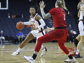 Virginia guard Dominique Toussaint (4) drives past Louisville forward Sam Fuehring (3) during the first half of an NCAA college basketball game Thursday, Feb. 21, 2019, in Charlottesville, Va.