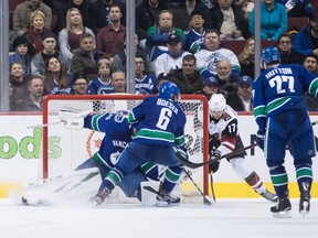 Arizona Coyotes' Alex Galchenyuk (17) scores the game-winning goal against Vancouver Canucks goalie Jacob Markstrom, of Sweden, as Canucks' Brock Boeser (6) and teammate Ben Hutton (27) watch during overtime NHL hockey action in Vancouver on Thursday, Feb. 21, 2019.