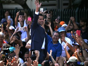 Venezuelan opposition leader Juan Guaido, who has declared himself the interim president, greets supporters at a demonstration demanding the resignation of President Nicolas Maduro, in Caracas.