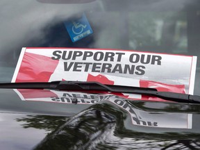 A sign is placed on a truck windshield as members of the advocacy group Banished Veterans protest outside the Veterans Affairs office in Halifax on Thursday, June 16, 2016. While most disabled veterans will see a small boost in financial support when the Trudeau government implements a new pension system in April, a new analysis shows some of the most severely injured will end up with less than under the current system.