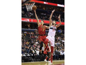 Atlanta Hawks guard Jeremy Lin (7) goes to the basket against Washington Wizards guard Tomas Satoransky (31) during the first half of an NBA basketball game, Monday, Feb. 4, 2019, in Washington.