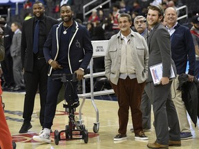 Washington Wizards guard John Wall, second from left, smiles next to team owner Ted Leonsis, third from left, before the team's NBA basketball game against the Cleveland Cavaliers, Friday, Feb. 8, 2019, in Washington.