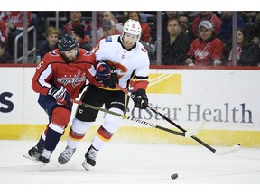 Calgary Flames left wing James Neal (18) battles for the puck against Washington Capitals defenseman Michal Kempny (6), of the Czech Republic, during the first period of an NHL hockey game Friday, Feb. 1, 2019, in Washington.