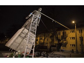 Activists in Poland pull down a statue of a prominent deceased priest, Father Henryk Jankowski, who allegedly abused minors sexually, in Gdansk, Poland, on Thursday Feb. 21, 2019. The activists said it was an act of protest against the Polish Catholic Church for failing in resolving the problem of clergy sex abuse. The protest comes as Pope Francis has gathered church leaders from around the world at the Vatican to grapple with the church's sex abuse crisis.